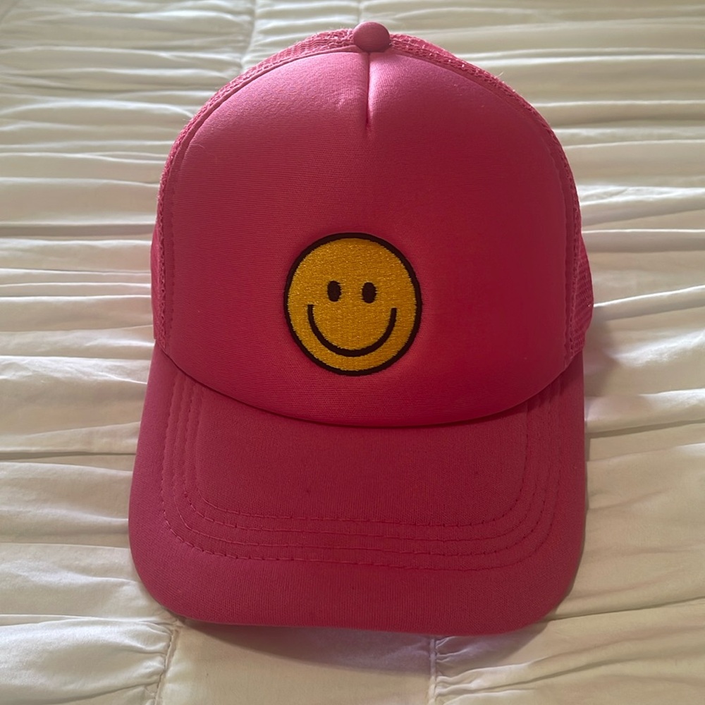Pink, adjustable smiley face trucker hat